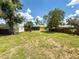Spacious backyard featuring mature trees and shed at 932 W Wheeler Rd, Brandon, FL 33510