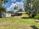 The backyard features a storage shed, a wood fence, and a screened in lanai at 932 W Wheeler Rd, Brandon, FL 33510