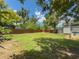 Large backyard with privacy fence and mature trees at 932 W Wheeler Rd, Brandon, FL 33510
