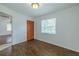 Bright bedroom features wood floors, closet, and window, offering a comfortable living space at 932 W Wheeler Rd, Brandon, FL 33510