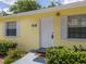 Charming yellow home featuring a well-maintained yard and inviting front entrance at 932 W Wheeler Rd, Brandon, FL 33510
