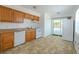 Well-lit kitchen features neutral countertops, white appliances, and a sliding door to the outside at 932 W Wheeler Rd, Brandon, FL 33510