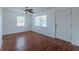 Bright living room with wood floors, white walls, ample natural light, and ceiling fan at 932 W Wheeler Rd, Brandon, FL 33510
