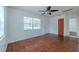 Bright, empty living room with wood floors, white walls, and ample natural light at 932 W Wheeler Rd, Brandon, FL 33510