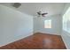Bright, empty living room with wood floors, white walls, ample natural light, and ceiling fan at 932 W Wheeler Rd, Brandon, FL 33510