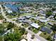 Community aerial view displaying waterway access, mature tree coverage and multiple residential dwellings at 621 Gran Kaymen Way, Apollo Beach, FL 33572