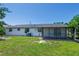 Home's backyard includes a screened in porch, green grass, and room for entertaining at 621 Gran Kaymen Way, Apollo Beach, FL 33572
