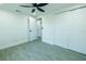 Bright bedroom with wood-look tile floor, closet and white doors at 621 Gran Kaymen Way, Apollo Beach, FL 33572