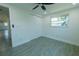 Bright bedroom features wood-look tile floor, a closet and natural light at 621 Gran Kaymen Way, Apollo Beach, FL 33572