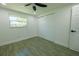 Bright bedroom features a window, closet and stylish wood-look tile floor at 621 Gran Kaymen Way, Apollo Beach, FL 33572