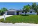 Well maintained single story home with a green lawn, a mailbox, and a two car garage at 621 Gran Kaymen Way, Apollo Beach, FL 33572