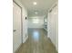 Bright hallway with wood-look tile leads to dining area and additional rooms at 621 Gran Kaymen Way, Apollo Beach, FL 33572