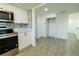 Kitchen featuring white cabinets, stainless steel appliances, tile backsplash, and modern fixtures at 621 Gran Kaymen Way, Apollo Beach, FL 33572