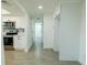 Bright kitchen featuring stainless steel appliances, white cabinets, tile backsplash, and updated fixtures at 621 Gran Kaymen Way, Apollo Beach, FL 33572