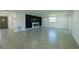 Modern living room showcasing new tile floors and a fireplace with eye-catching accent wall at 621 Gran Kaymen Way, Apollo Beach, FL 33572