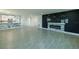 Spacious living room featuring modern tile flooring and a decorative fireplace feature wall at 621 Gran Kaymen Way, Apollo Beach, FL 33572