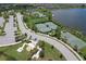 Aerial view of community with tennis courts, basketball court, lake, and playground at 10081 Sage Creek Dr, Sun City Center, FL 33573