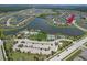Aerial view of a community featuring lake, pool, tennis courts, and modern homes at 10081 Sage Creek Dr, Sun City Center, FL 33573