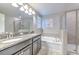 Bathroom features a double sink vanity, soaking tub, and a separate shower at 10081 Sage Creek Dr, Sun City Center, FL 33573