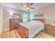 Comfortable bedroom with hardwood floors, large window, and warm decor at 10081 Sage Creek Dr, Sun City Center, FL 33573