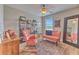Cozy bedroom with unique decor, ample lighting, and relaxing seating at 10081 Sage Creek Dr, Sun City Center, FL 33573