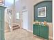 Welcoming foyer with tile flooring, staircase, and stylish decor at 10081 Sage Creek Dr, Sun City Center, FL 33573
