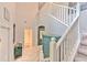 Elegant foyer with high ceilings, staircase, and a striking blue accent chest at 10081 Sage Creek Dr, Sun City Center, FL 33573