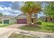Well-maintained home with a brick driveway, two-car garage, and mature landscaping at 10081 Sage Creek Dr, Sun City Center, FL 33573