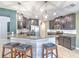 Kitchen featuring granite counters, stylish barstool seating and stainless appliances at 10081 Sage Creek Dr, Sun City Center, FL 33573