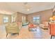 Bright living room with neutral tones, tile floors, and stylish furnishings at 10081 Sage Creek Dr, Sun City Center, FL 33573