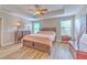 Spacious main bedroom with tray ceiling, wood floors, and abundant natural light at 10081 Sage Creek Dr, Sun City Center, FL 33573