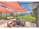 Screened patio featuring an outdoor dining table set and peaceful lake views at 10081 Sage Creek Dr, Sun City Center, FL 33573