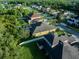 Beautiful aerial view of a home featuring a private pool and a well-maintained lawn in a lush, green neighborhood at 10513 Palm Cove Ave, Tampa, FL 33647