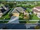 Beautiful aerial view of home featuring manicured landscaping, a three-car garage, and a well-maintained lawn at 10513 Palm Cove Ave, Tampa, FL 33647