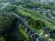 Aerial view of a residential community next to a golf course with lush greenery and lakes at 10513 Palm Cove Ave, Tampa, FL 33647