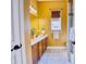 Bathroom with a double vanity, marble floors, and a window providing natural light at 10513 Palm Cove Ave, Tampa, FL 33647