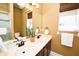 Bathroom featuring double sinks, a large mirror, and a tiled shower at 10513 Palm Cove Ave, Tampa, FL 33647