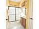 Bathroom with glass-enclosed shower, window with curtains, and marble tile floor at 10513 Palm Cove Ave, Tampa, FL 33647