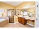 Well-lit bathroom featuring a glass-enclosed shower, soaking tub, and a vanity with a makeup area at 10513 Palm Cove Ave, Tampa, FL 33647