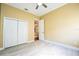 Bright bedroom with white floors, white closet doors, and light yellow walls at 10513 Palm Cove Ave, Tampa, FL 33647