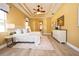Spacious bedroom features a bed, wood floors, tray ceiling, and multiple windows at 10513 Palm Cove Ave, Tampa, FL 33647