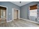 Bedroom features a window with decorative curtains and an open closet at 10513 Palm Cove Ave, Tampa, FL 33647