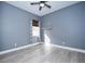 Bedroom with window, custom curtains, and light blue walls at 10513 Palm Cove Ave, Tampa, FL 33647