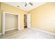 Bedroom with a ceiling fan, wood-look floors, and access to a closet at 10513 Palm Cove Ave, Tampa, FL 33647