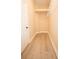 Walk-in closet featuring hardwood floors, wire shelving and ample storage space at 10513 Palm Cove Ave, Tampa, FL 33647