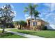 Well-maintained single-story home with a three-car garage, lush landscaping, and beautiful curb appeal at 10513 Palm Cove Ave, Tampa, FL 33647