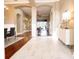 Bright hallway featuring hardwood floors, archways, and views into other living areas at 10513 Palm Cove Ave, Tampa, FL 33647