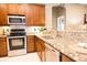 Beautiful kitchen with stainless steel appliances, granite counters, and stylish backsplash at 10513 Palm Cove Ave, Tampa, FL 33647