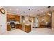 Open-concept kitchen with stainless steel appliances, granite countertops, and seamless flow to the living area at 10513 Palm Cove Ave, Tampa, FL 33647