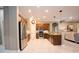 Open concept kitchen with stainless steel appliances, granite counters, and modern lighting at 10513 Palm Cove Ave, Tampa, FL 33647